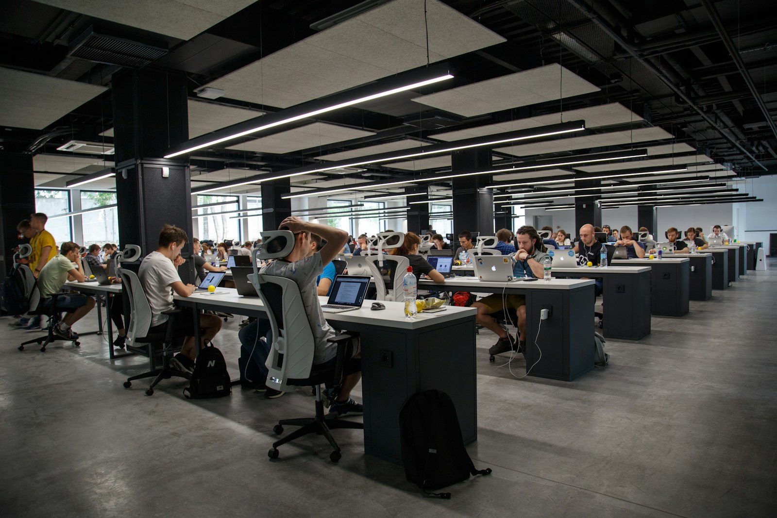 Open-plan newsroom with people working at laptops